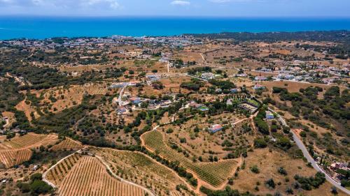 an aerial view of a village on a hill next to the ocean at Quinta dos Capinhas in Porches