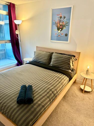 a bedroom with a bed with blue pillows on it at Cozy Condo near CN Tower in Toronto