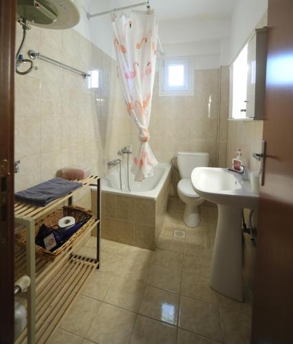a bathroom with a tub and a toilet and a sink at The Bliss Z1 in Kastoria