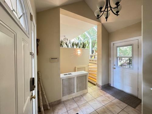 a hallway with a white door and a window at Spacious 4-Bedrooms Friendly House-Pool-Parking in Markham