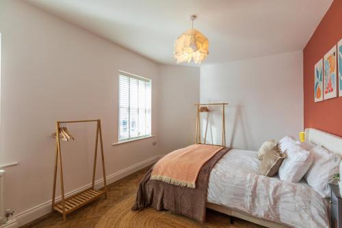 a bedroom with a bed and a chandelier at Spacious 2-Bed Flat with Panoramic Views in Portsmouth