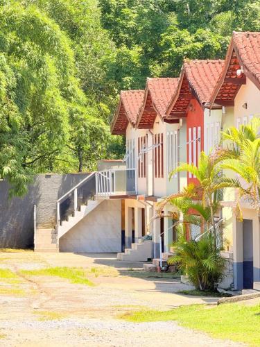 a row of houses with stairs and trees at Casa em Condomínio com Wi-Fi - 300m da praia in Ubatuba