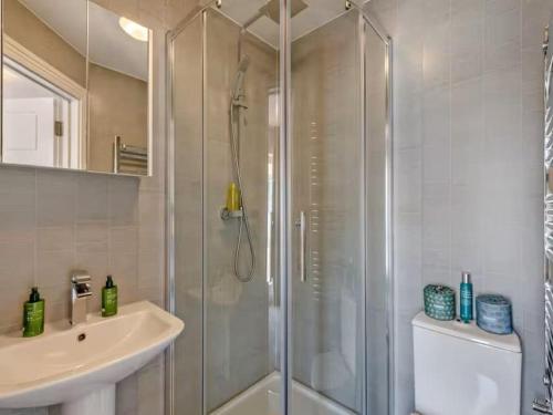 a bathroom with a shower and a sink at Beachside Bliss in Paignton