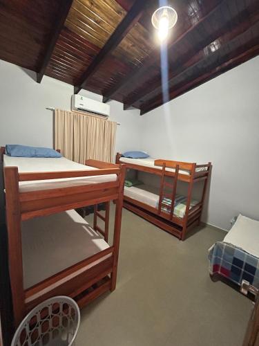 a room with three bunk beds and a light at Alojamiento LA PERSEA in Encarnación