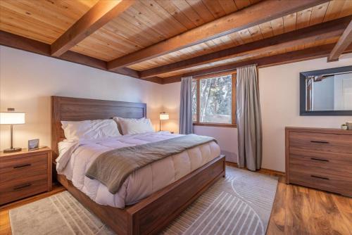 a bedroom with a large bed and a window at Dollar Point - Observation Dr, home in Tahoe City