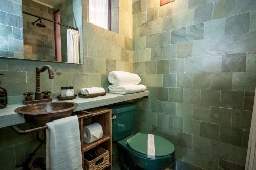 a bathroom with a sink and a toilet at Hotel Casa de las Abuelas in Guanajuato