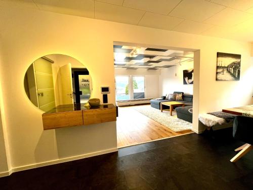 a living room with a large mirror on the wall at Traum Berg - Koppelberg 2 in Traben-Trarbach