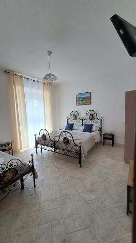 a bedroom with two beds with blue pillows at La tappa del vignaiolo B&B in Mamoiada