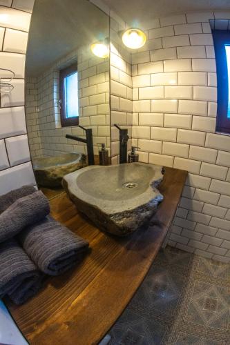 a bathroom with a large stone sink on a wooden counter at Chata Geruša in Čebovce