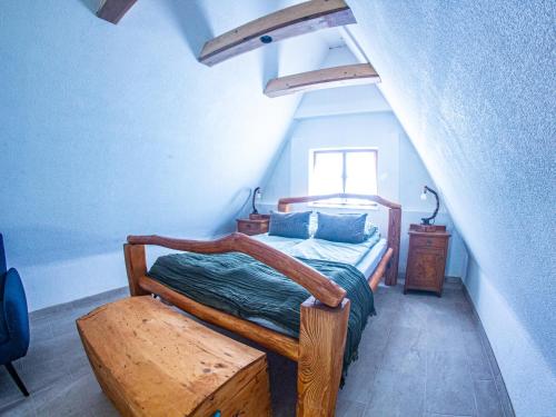 a bedroom with a wooden bed and a window at Chata Geruša in Čebovce