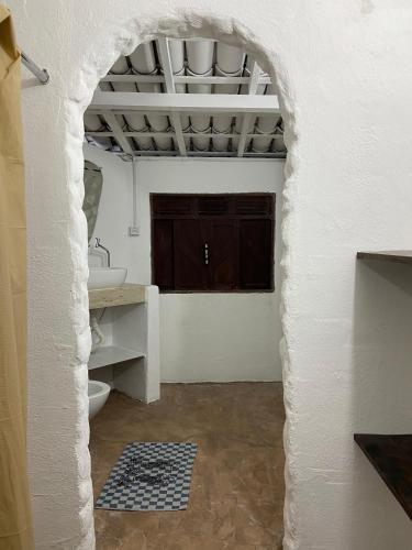 a white bathroom with a sink and a toilet at Pousada Nosso Sonho in Natal