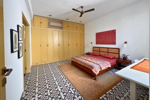 a bedroom with a bed and yellow cabinets at A Modern 2BHK Private Villa in Vagator - Valenades in Vagator