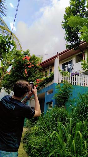 a man taking a picture of a house at Shalom breaze in Gettapola