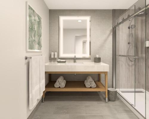 a bathroom with a sink and a shower at EVEN Hotel Orlando Universal Blvd by IHG in Orlando