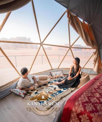 a group of three people sitting in a yurt at RUM KANARA BUBBLE lUXURY CAMP in Wadi Rum