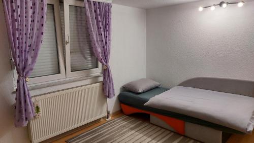 a small room with a bed and a window at Gajic & Milini in Banja Luka