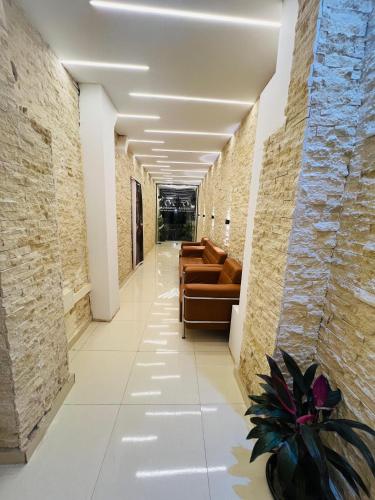 a hallway with couches and a plant in a building at El Nabila Front Pyramids & Sphinx View in Cairo