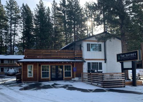 a building with a sign in front of it in the snow at The Jeffrey Hotel in South Lake Tahoe