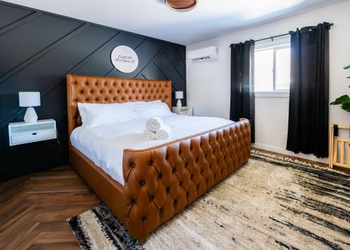 a bedroom with a large bed with a brown headboard at Chalet 239-Boutique Hotel in West Dover