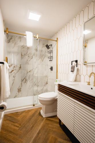 a bathroom with a shower and a toilet and a sink at Chalet 239-Boutique Hotel in West Dover