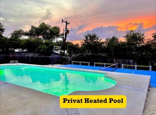 a large swimming pool with a sunset in the background at 4 Bed sleeps 12 -Sea world-Six Flags-Down Town - Emerald Oasis in San Antonio