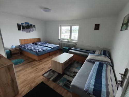 a living room with two beds and a couch at Čučo Privat in Tatranska Strba