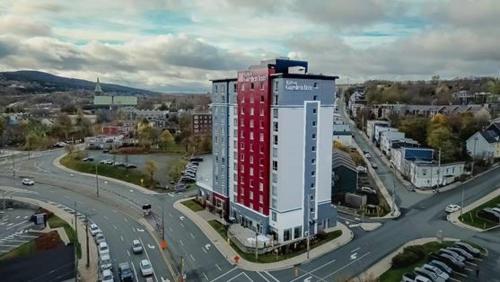 a tall red and white building in a city at Hilton Garden Inn St. John's Newfoundland, Canada in St. John's