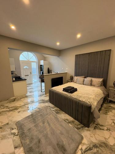 a large bedroom with a bed and a fireplace at The Norwich Hideaway - Private Hot Tub in Norwich