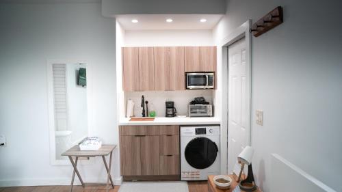 a small kitchen with a stove and a microwave at Stylish Studio Near Wynwood & Design District in Miami