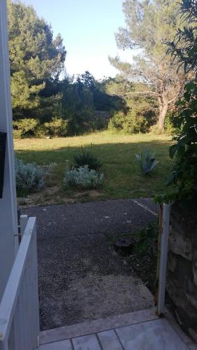 a driveway leading to a yard with a field at Green Garden in Gajac