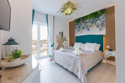 a bedroom with a large bed and a large window at Aurum Pompei Suites in Pompei