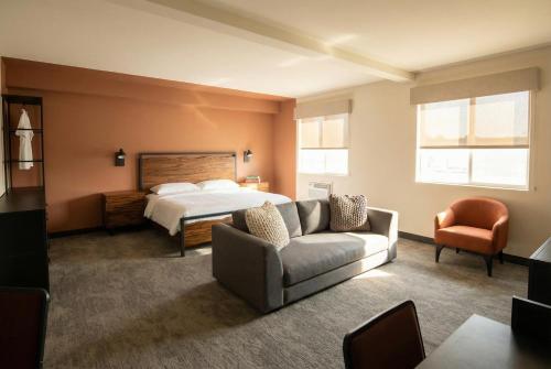a bedroom with a bed and a couch and a bed at The Outrider Hotel in Manitou Springs