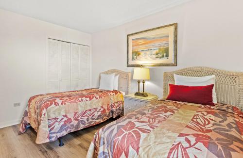 two beds sitting next to each other in a room at Ocean Creek Resort in Myrtle Beach