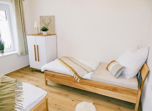 a couch with pillows on it in a living room at Ferienwohnung Schusternagerl in Simbach