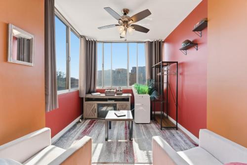 an office with red walls and a ceiling fan at Lovely 2BR Condo WFH Heart of Downtown Pool Access in Atlanta