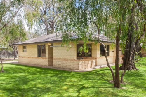 a house in a park with green grass at Siesta Park Holiday Resort ABSOLUTE BEACHFRONT RESORT in Busselton