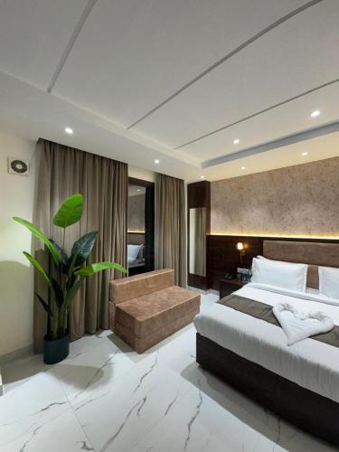 a bedroom with a large bed and a couch at The Aero Lounge Hotel 2kms From Airport in Amritsar