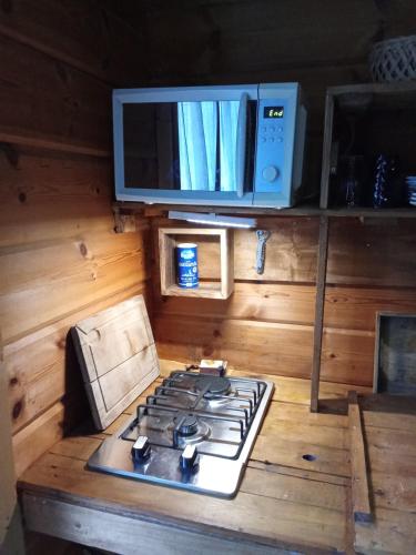 a kitchen with a stove top and a microwave at studio in Puessans