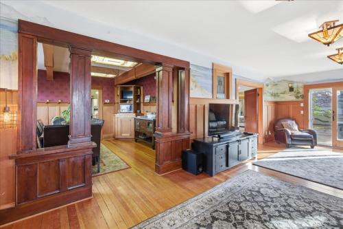 a large living room with wood paneling and a kitchen at Coastal Craftsman in Pacific City
