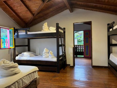 a room with two bunk beds and a doorway at Finca Hotel Mariangel in El Peñol