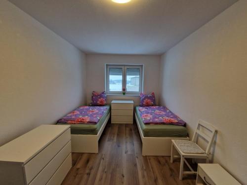 a room with two beds and a window at Monteurwohnung RoomWork24 - 10 Betten - Twistringen in Twistringen