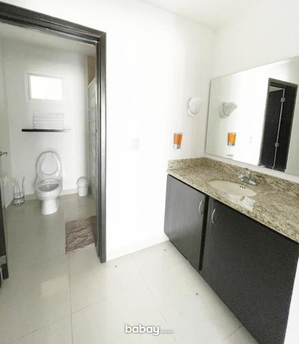 a bathroom with a sink and a toilet at Departamento Isla Marina Mazatlán con alberca in Mazatlán