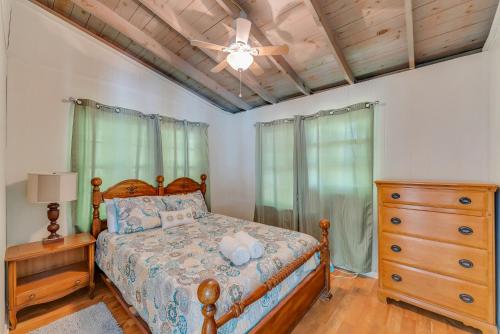 a bedroom with a bed and a ceiling fan at What A View - Zero Steps To The Dock! Yearround Water in Crane Hill