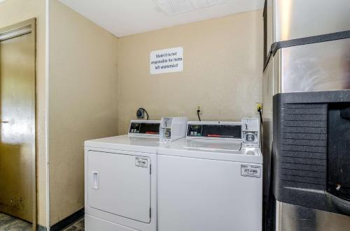 a kitchen with two microwaves on top of a refrigerator at Motel 6-Newark, DE in Newark