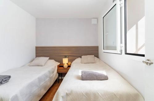 two beds in a small room with a window at Villa Perdices in Fuengirola
