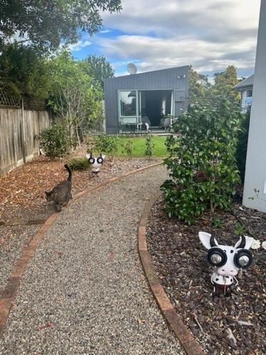 a house with a garden with fake cows and a bird at Thornton Hideaway in Cambridge