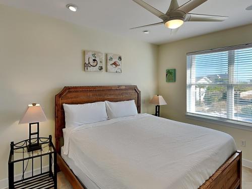 a bedroom with a bed and a ceiling fan at Lazy Urchin Seaclusion in Pensacola Beach