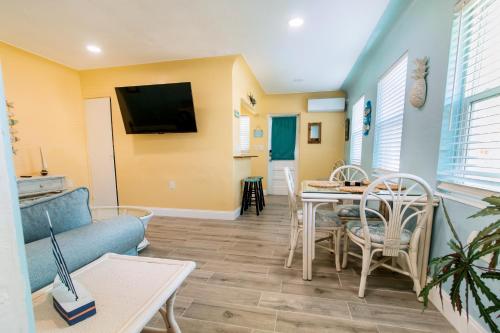 a living room with a couch and a table at Gorgeous Beach Condo in St. Petersburg
