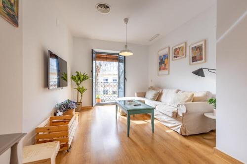 a living room with a couch and a table at Alma de San Bernardo in Seville