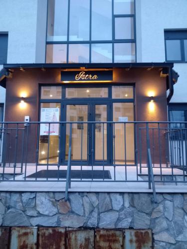 a store with a sign on the front of a building at Aria lux Titova vila in Zlatibor
